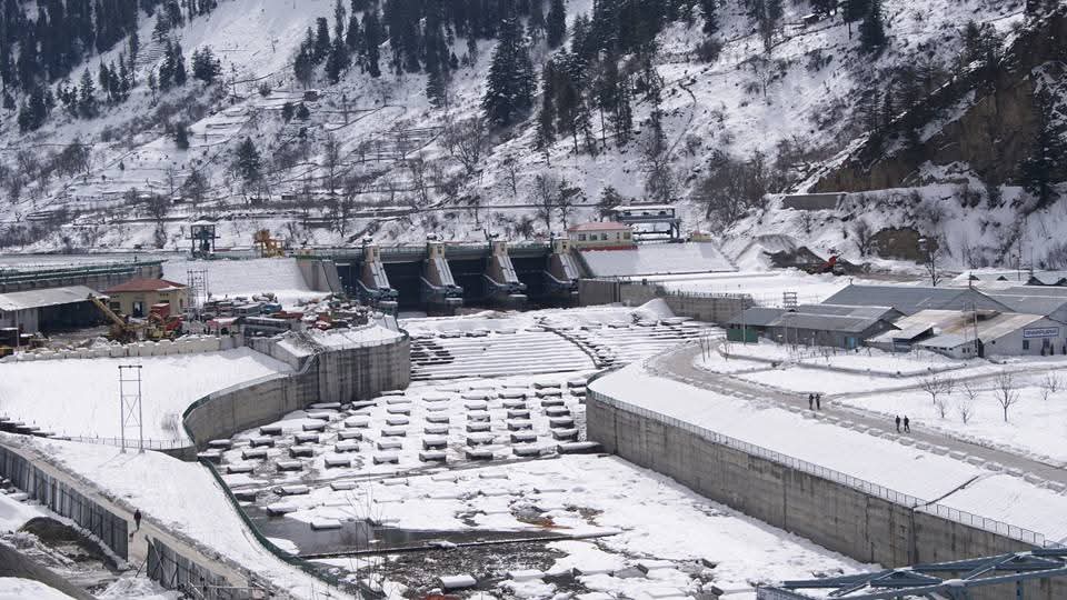 Snowy landscape with dam and river